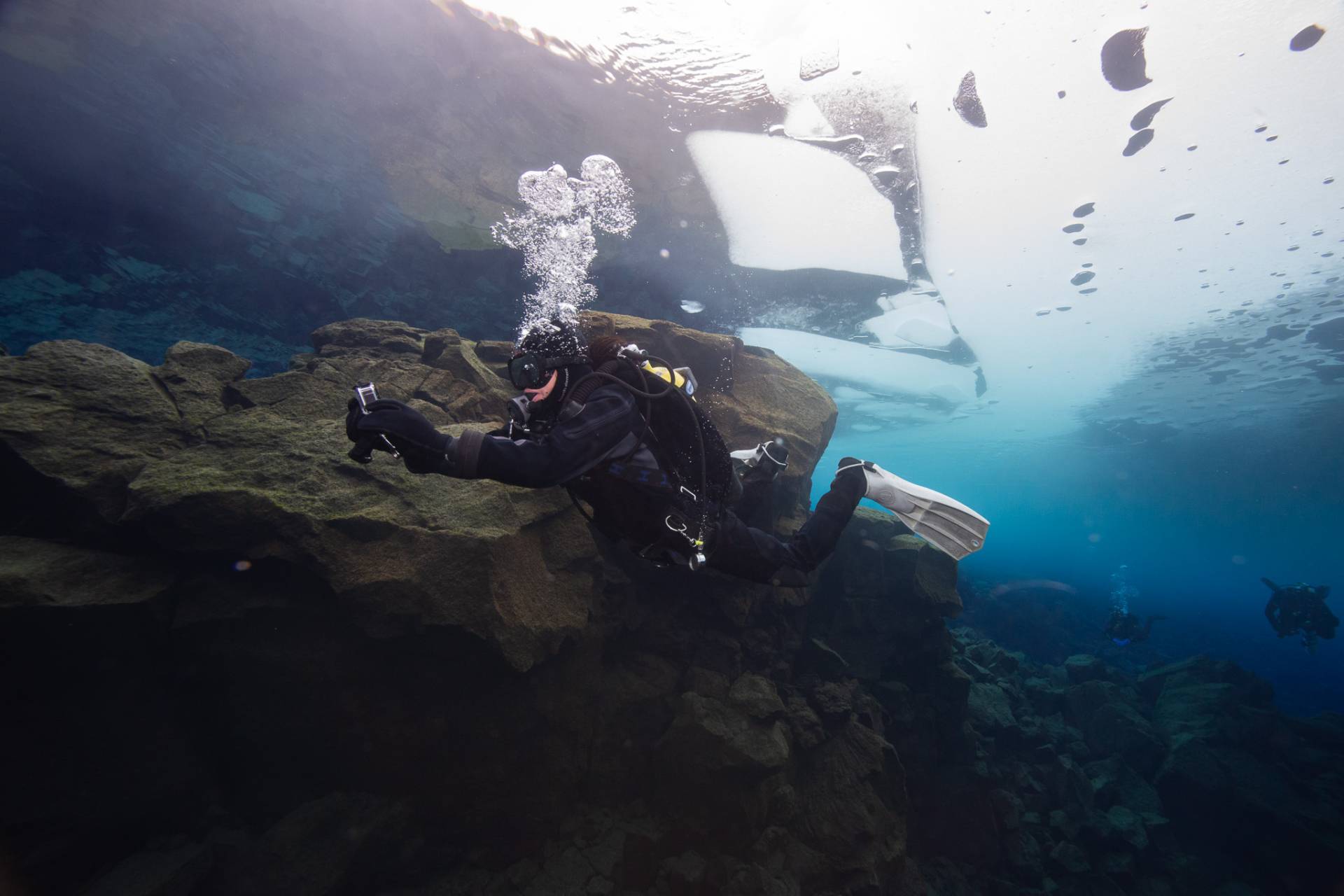 Diver coming up from under the ice in lake Thingvellir.