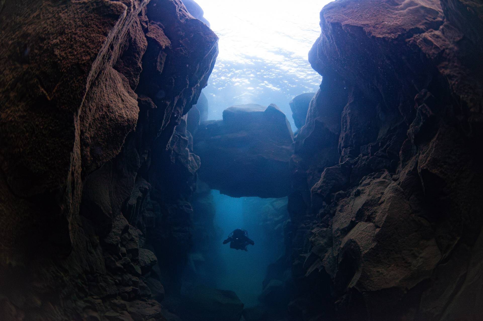 Diver under a rock, Thingvallarvatn