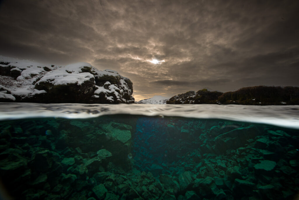 Picture from Davidsgja. Middle of winter with low sun and snow around top. Lower half of picture is underwater.